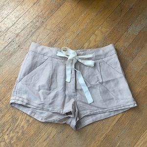 mauve cuffed linen shorts with white tie